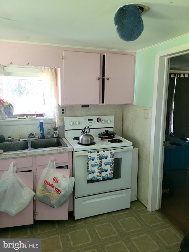 kitchen with white cabinets, white range with electric stovetop, and sink