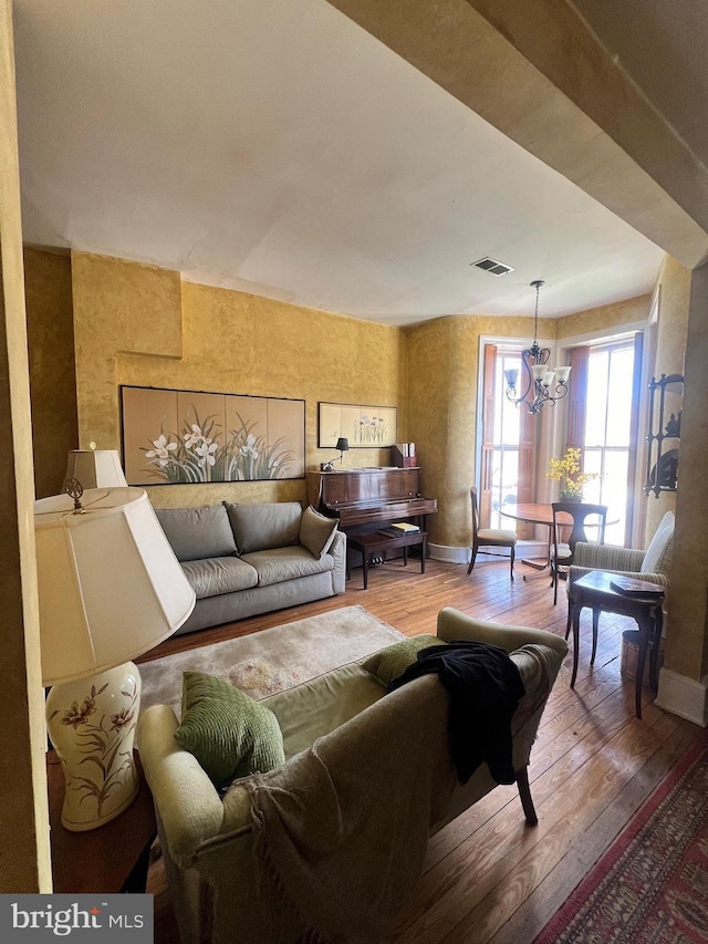 living room featuring hardwood / wood-style floors and an inviting chandelier