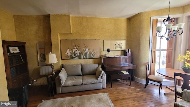 sitting room featuring hardwood / wood-style floors and a chandelier