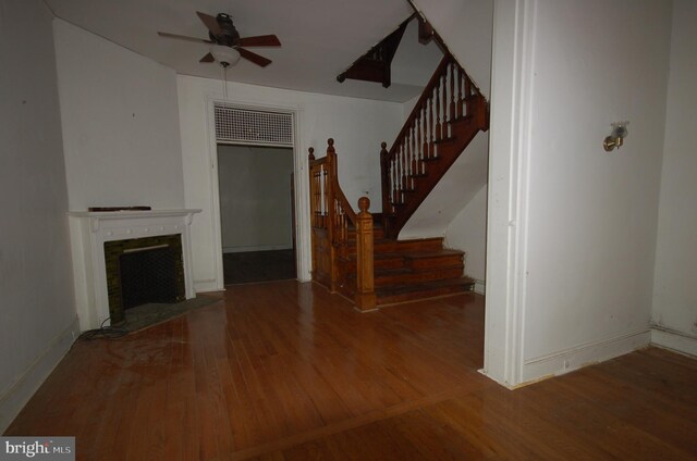 unfurnished living room with hardwood / wood-style floors and ceiling fan