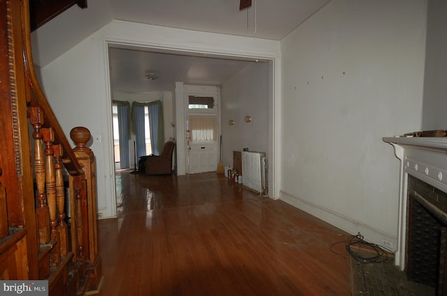 foyer with radiator and hardwood / wood-style flooring