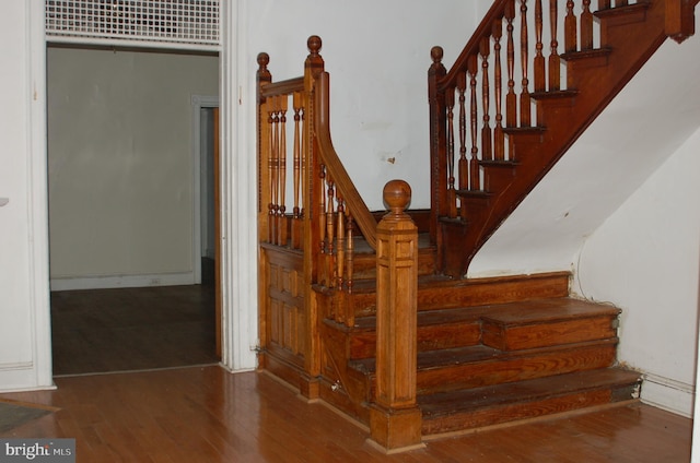 stairs featuring hardwood / wood-style floors