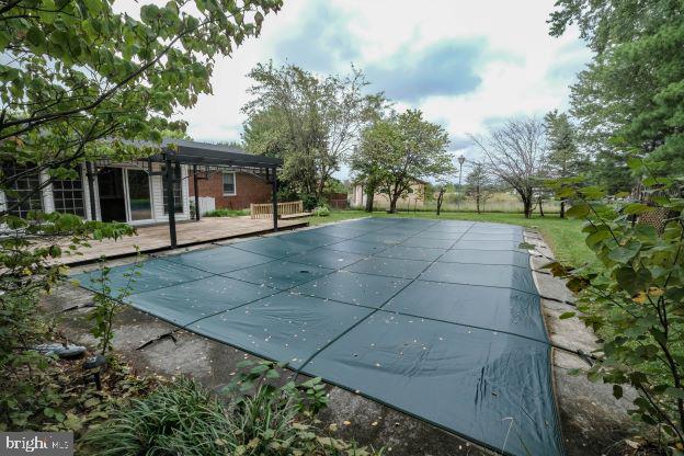 view of swimming pool featuring a patio and a pergola