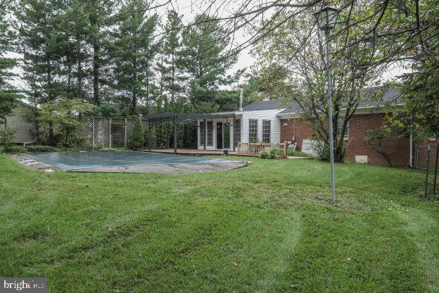 view of yard featuring a covered pool