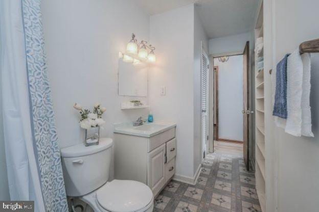 bathroom featuring vanity and toilet