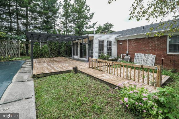 view of yard with a wooden deck and a pergola