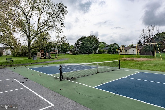 view of sport court with a playground, basketball court, and a lawn