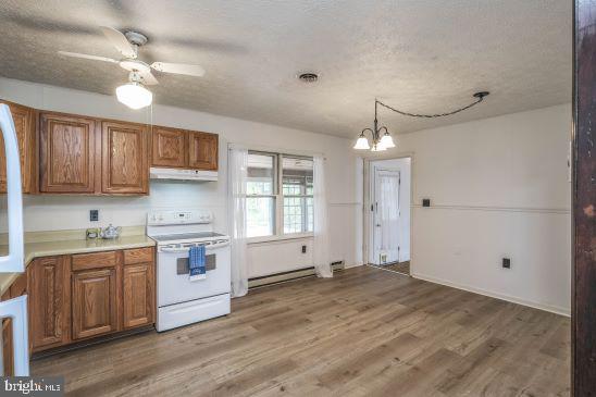 kitchen with white range with electric cooktop, dark hardwood / wood-style floors, hanging light fixtures, a baseboard heating unit, and a textured ceiling