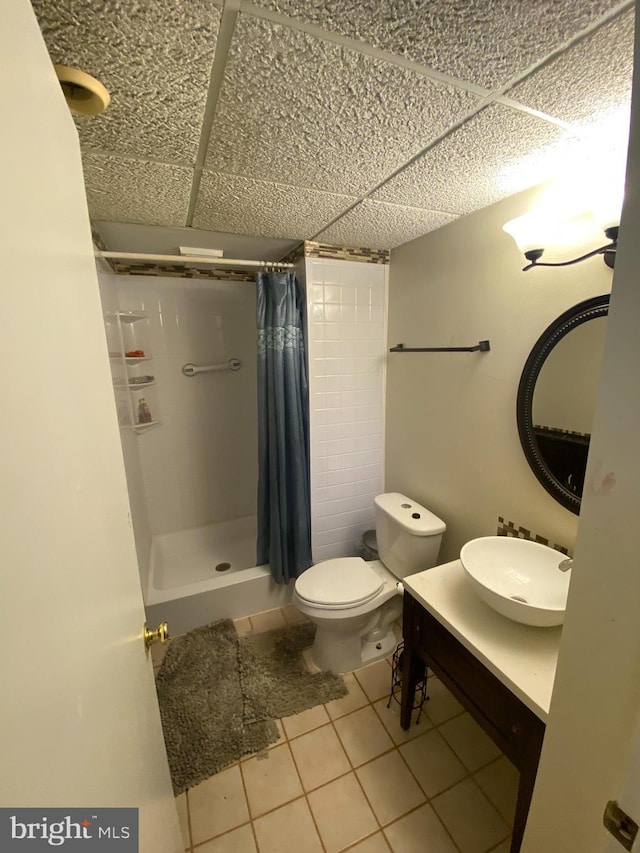 1184 Bannister Cir, Waldorf, MD 20602 - bathroom featuring a paneled ceiling, a shower stall, tile patterned flooring, vanity, and toilet