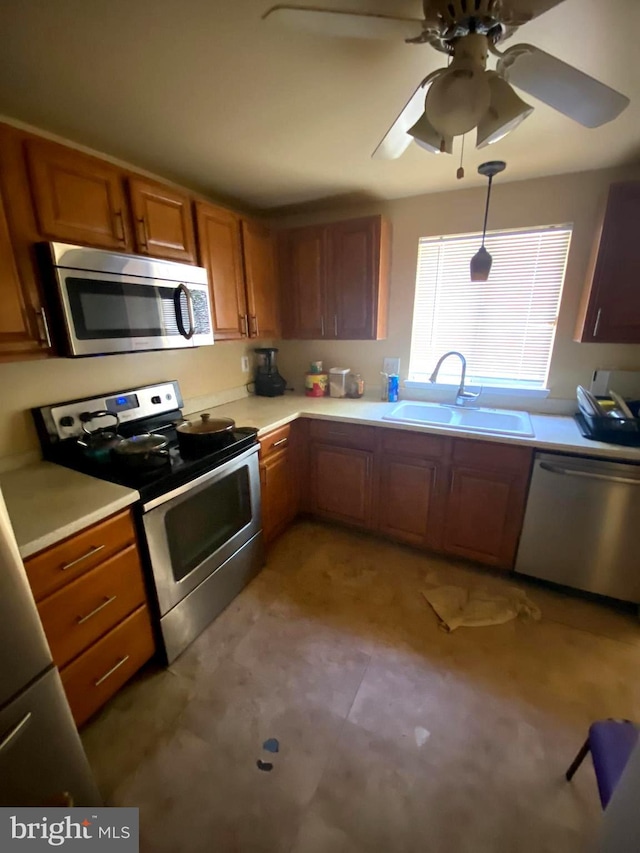 1184 Bannister Cir, Waldorf, MD 20602 - kitchen with appliances with stainless steel finishes, a sink, brown cabinetry, light countertops, and a ceiling fan