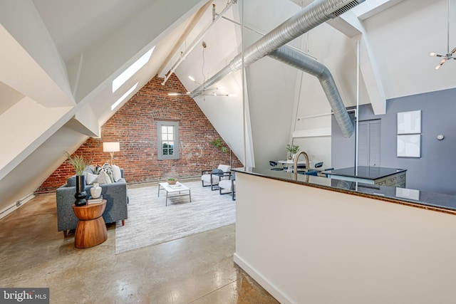 interior space featuring concrete flooring, high vaulted ceiling, a skylight, beam ceiling, and brick wall