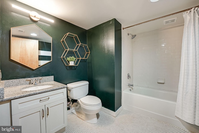 full bathroom featuring toilet, vanity, tile patterned floors, and shower / tub combo