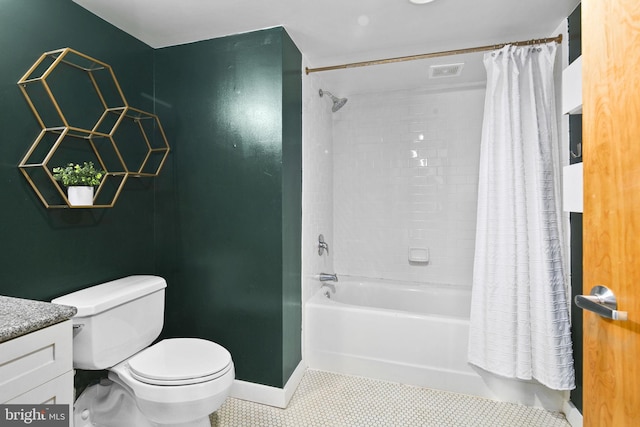 full bathroom featuring toilet, vanity, tile patterned floors, and shower / tub combo with curtain