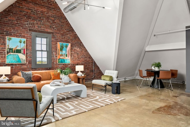 living area featuring high vaulted ceiling, finished concrete flooring, and brick wall