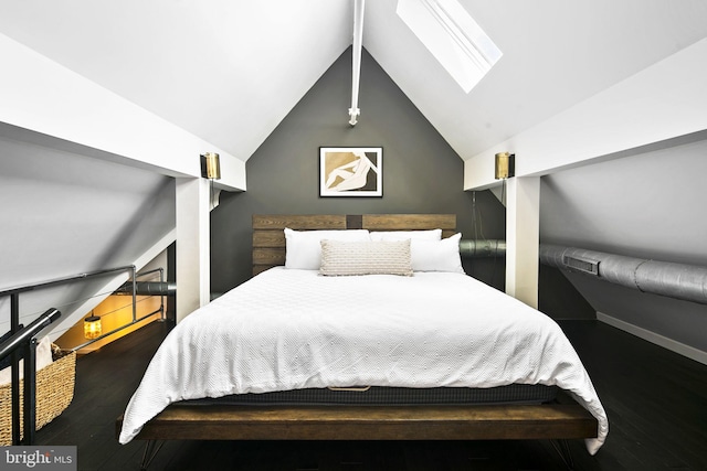 bedroom with vaulted ceiling with skylight and dark hardwood / wood-style flooring