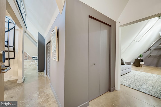 hallway featuring high vaulted ceiling