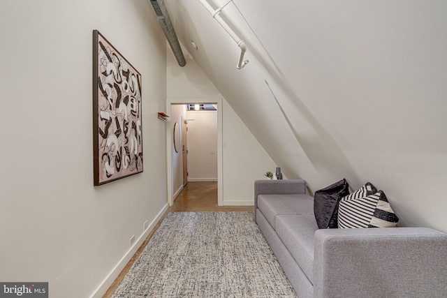 interior space featuring wood-type flooring and lofted ceiling with beams