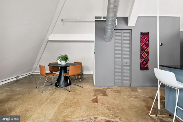 dining room with concrete floors and baseboards