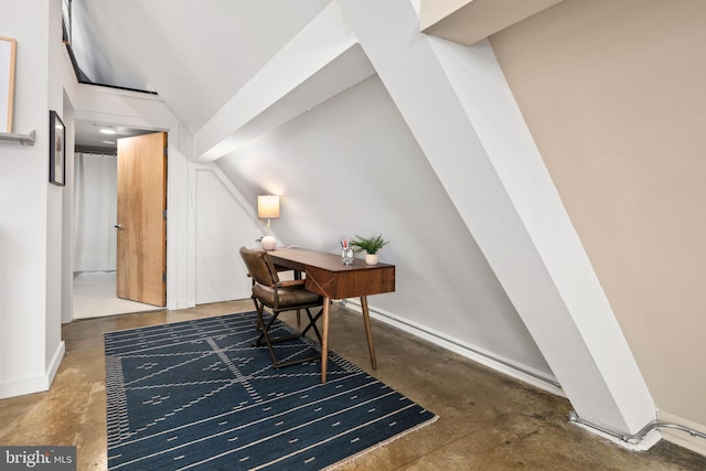 office with baseboards, vaulted ceiling, and concrete flooring