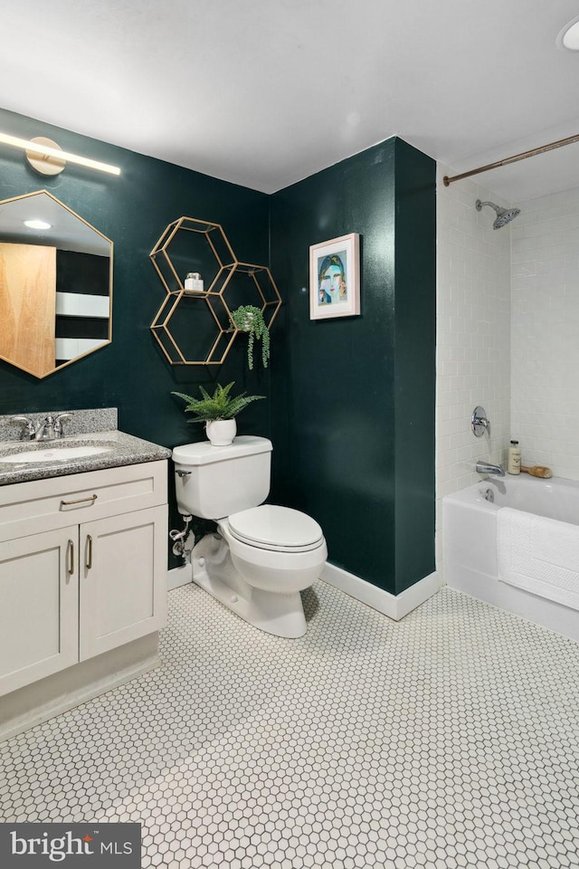 full bath featuring tub / shower combination, vanity, toilet, and baseboards