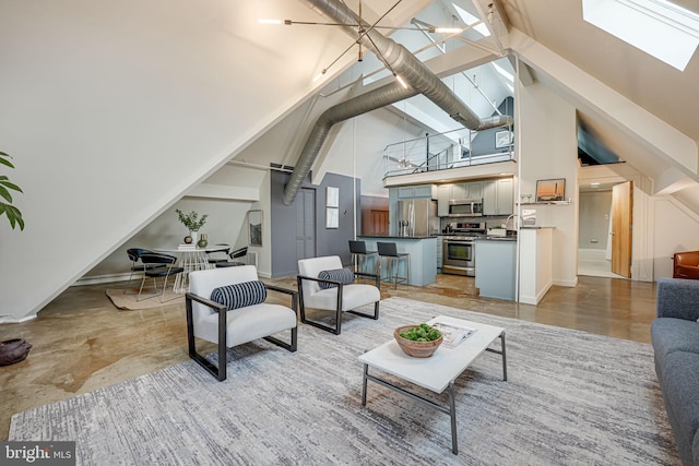 living room featuring high vaulted ceiling, sink, and a skylight