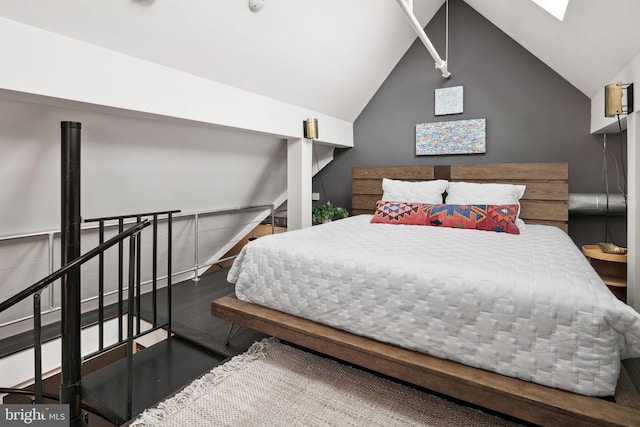 bedroom with dark hardwood / wood-style flooring and lofted ceiling