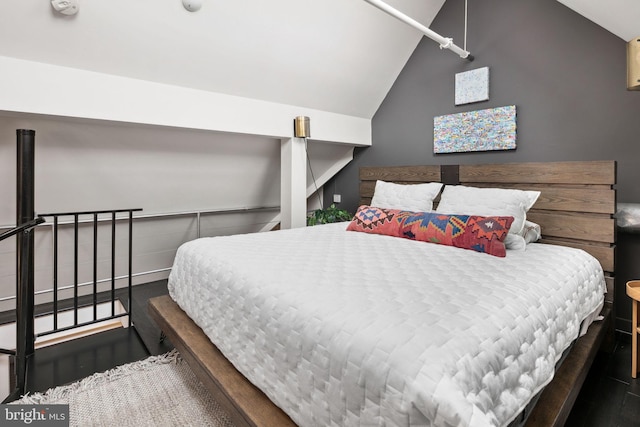 bedroom with dark wood-type flooring and vaulted ceiling