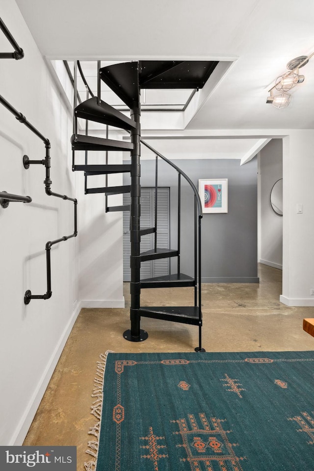 stairs with baseboards and concrete flooring