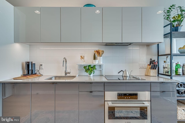 57 N St NW Unit 433, Washington, DC 20001 - kitchen featuring modern cabinets, gray cabinets, a sink, stainless steel oven, and black electric stovetop