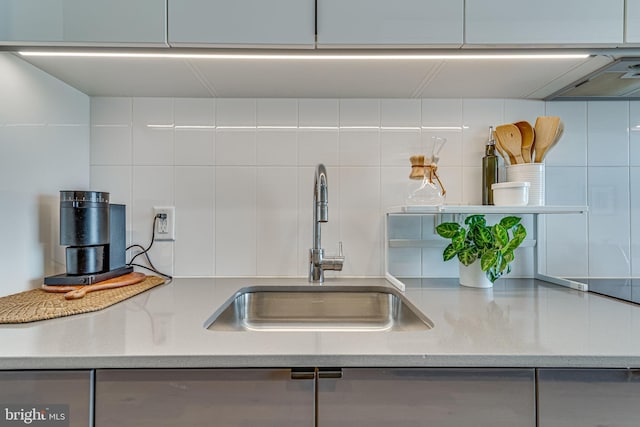 57 N St NW Unit 433, Washington, DC 20001 - kitchen featuring a sink, decorative backsplash, light stone counters, and white cabinetry