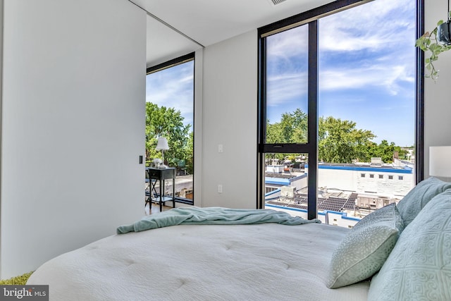 bedroom with floor to ceiling windows