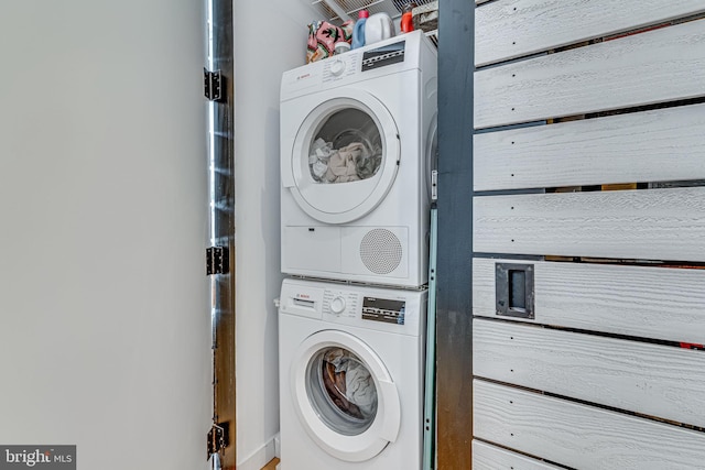 laundry area with stacked washer and clothes dryer