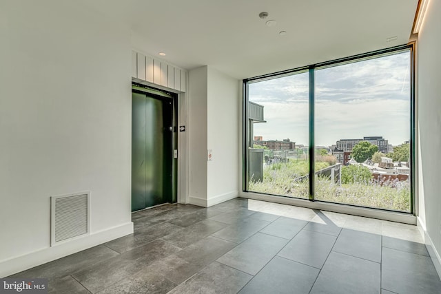 57 N St NW Unit 433, Washington, DC 20001 - spare room with visible vents, a wall of windows, and baseboards