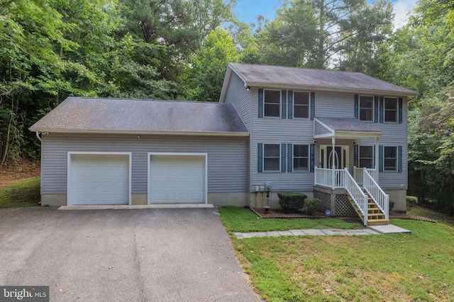 colonial inspired home with a garage and a front yard