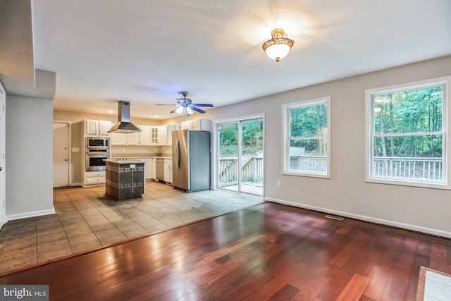 unfurnished living room featuring ceiling fan and light hardwood / wood-style flooring