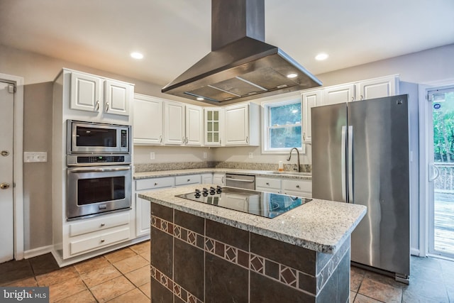 kitchen featuring white cabinets, appliances with stainless steel finishes, island range hood, and a kitchen island