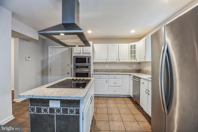 kitchen with appliances with stainless steel finishes, island range hood, white cabinetry, and a kitchen island