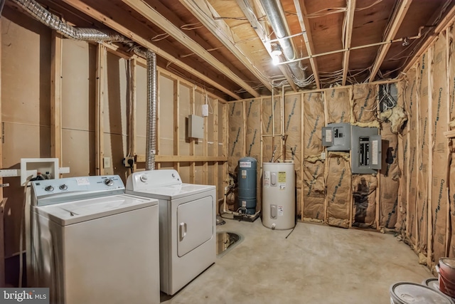 washroom featuring water heater, electric panel, and washing machine and clothes dryer