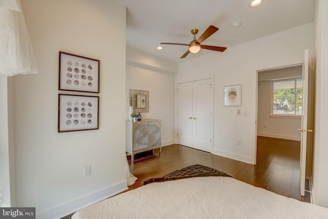 unfurnished bedroom with a closet, ceiling fan, and dark wood-type flooring