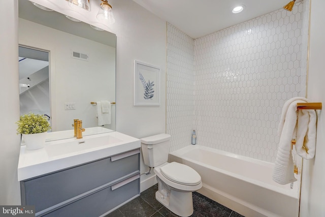 full bathroom with tile patterned flooring, tiled shower / bath combo, toilet, and vanity