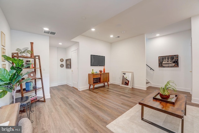 living room with light hardwood / wood-style flooring