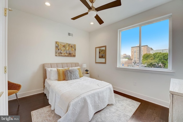 bedroom with dark hardwood / wood-style floors and ceiling fan