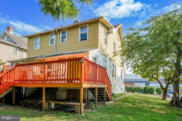 rear view of property with a yard and a wooden deck