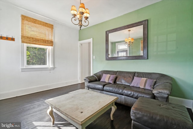 living room featuring an inviting chandelier and dark wood-type flooring