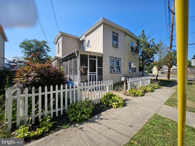 view of front of property featuring a sunroom