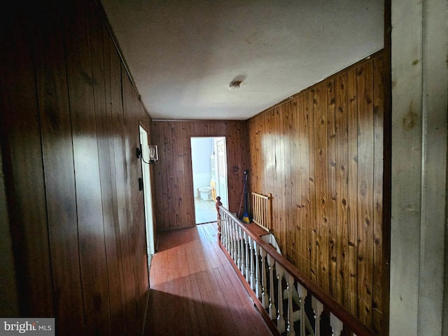 hall featuring wooden walls and hardwood / wood-style floors