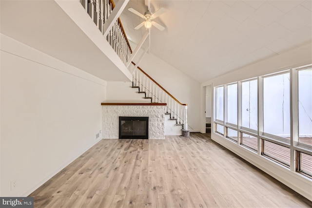 unfurnished living room featuring light hardwood / wood-style flooring and ceiling fan