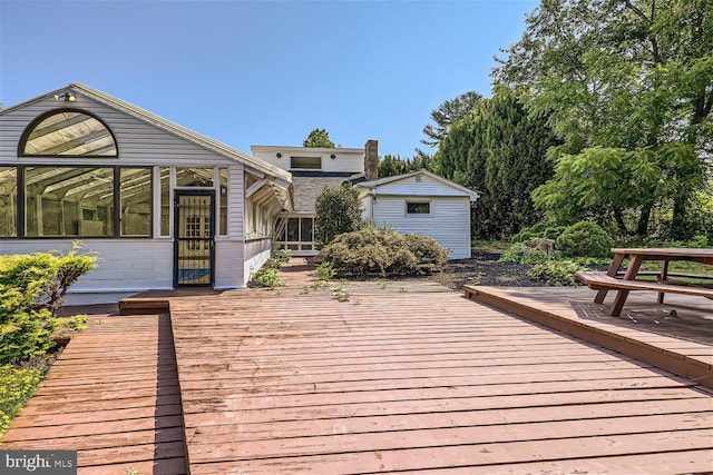 wooden deck with an outbuilding