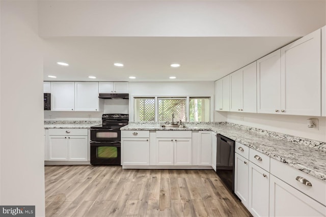 kitchen with black appliances, white cabinets, sink, light hardwood / wood-style floors, and light stone counters