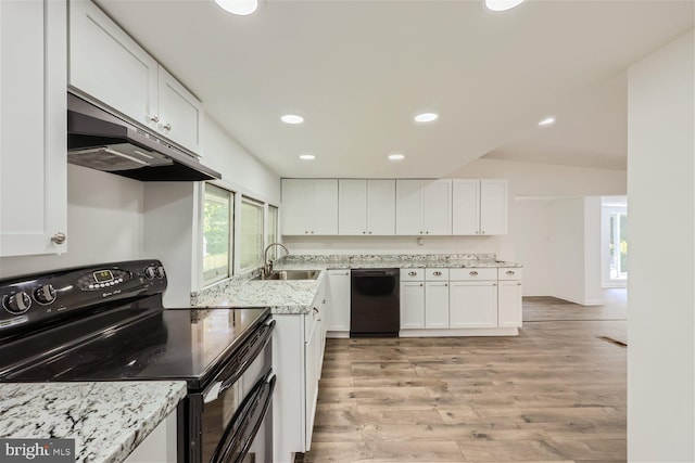 kitchen featuring black appliances, light stone counters, white cabinetry, and sink